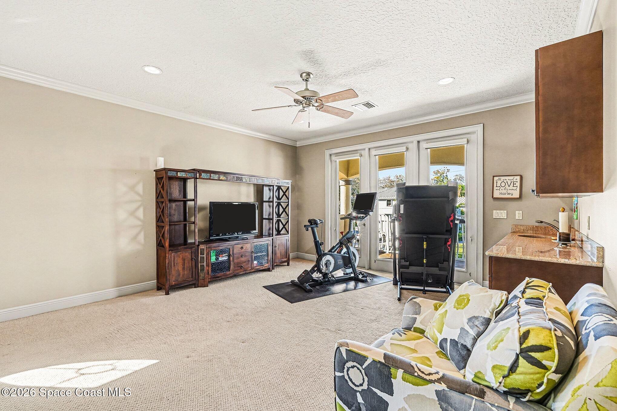 1 Point View Place Cocoa, FL 32926 - Photo 23 of 45 a living room with furniture a flat screen tv and a floor to ceiling window
