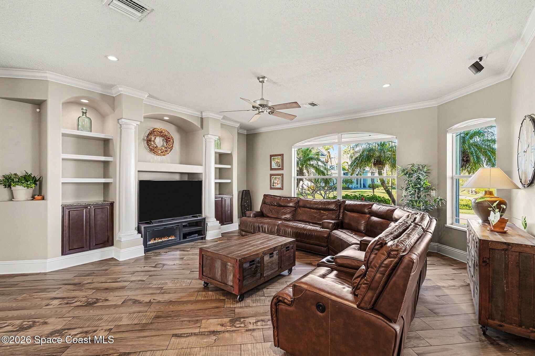 1 Point View Place Cocoa, FL 32926 - Photo 8 of 45 a living room with furniture a fireplace and a large window