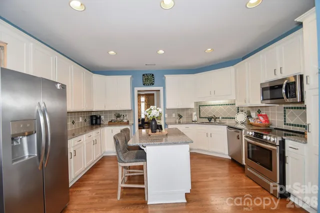a kitchen with counter top space cabinets and stainless steel appliances