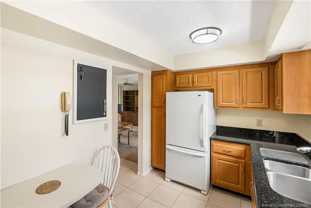 a white refrigerator freezer sitting in a kitchen