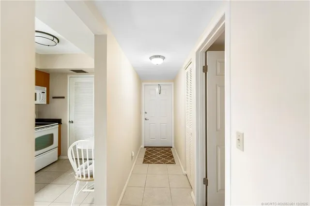 a view of a hallway with wooden floor and dining room