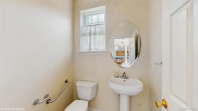 a bathroom with a sink a mirror and a toilet
