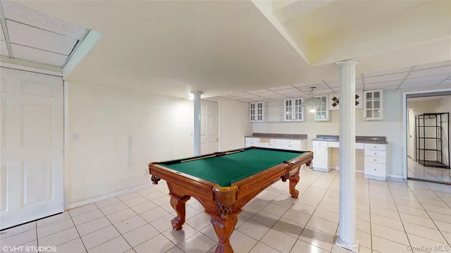 a living room with furniture a table and kitchen view