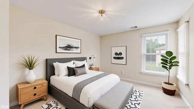 a bedroom with a bed and a potted plant