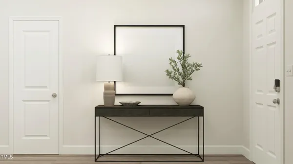 a kitchen with stainless steel appliances kitchen island granite countertop a refrigerator a stove a sink and white cabinets with wooden floor