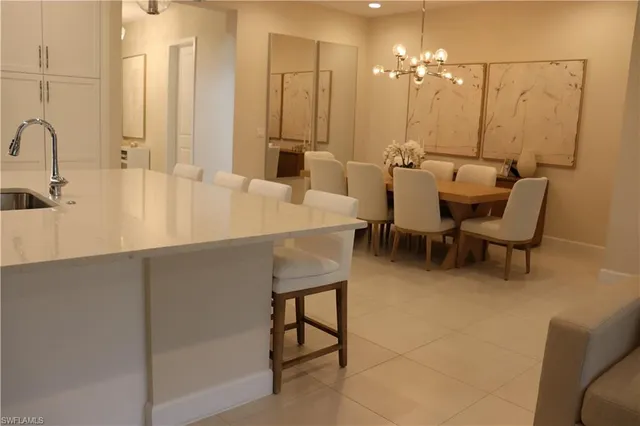 a room with table chairs and mirrors