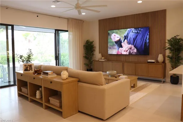 a living room with furniture a rug and a large window