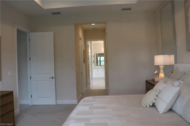 a bedroom with a bed and a lamp