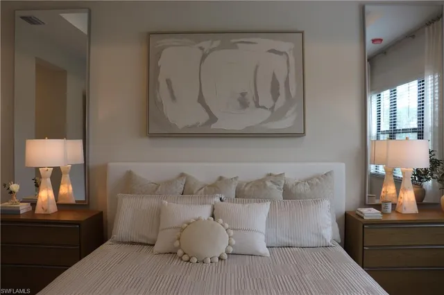 a bed room with a bed and a night stand