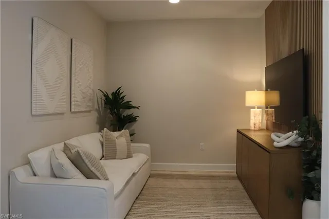 a living room with furniture and a potted plant