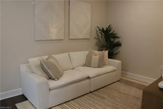 a living room with furniture and a walk in closet