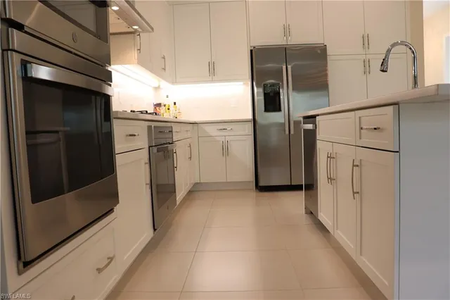a kitchen with a refrigerator and a sink