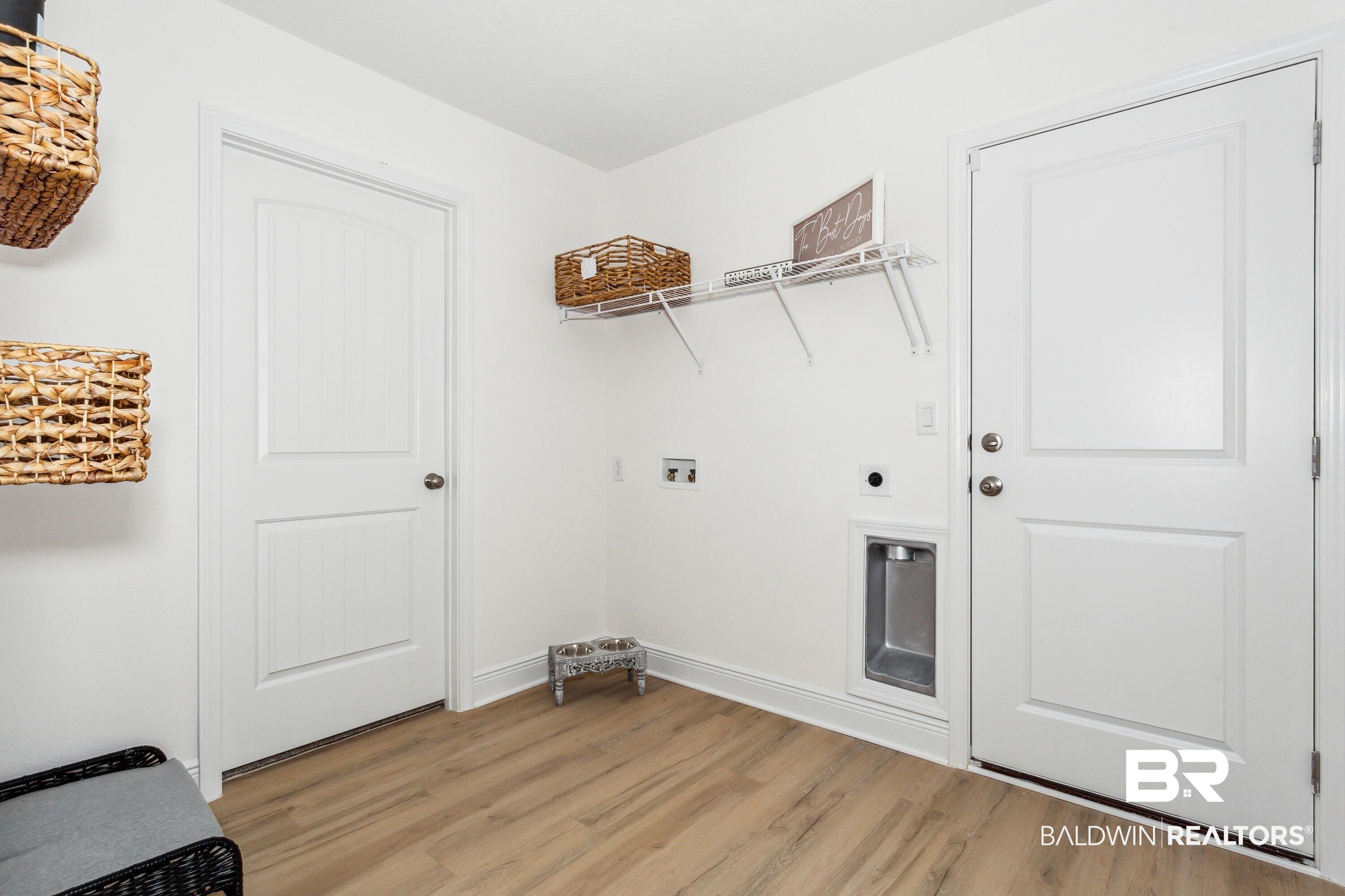 150 St Stephens Court Atmore, AL 36502 - Photo 18 of 21 Clothes washing area featuring hookup for an electric dryer, light hardwood / wood-style flooring, and washer hookup