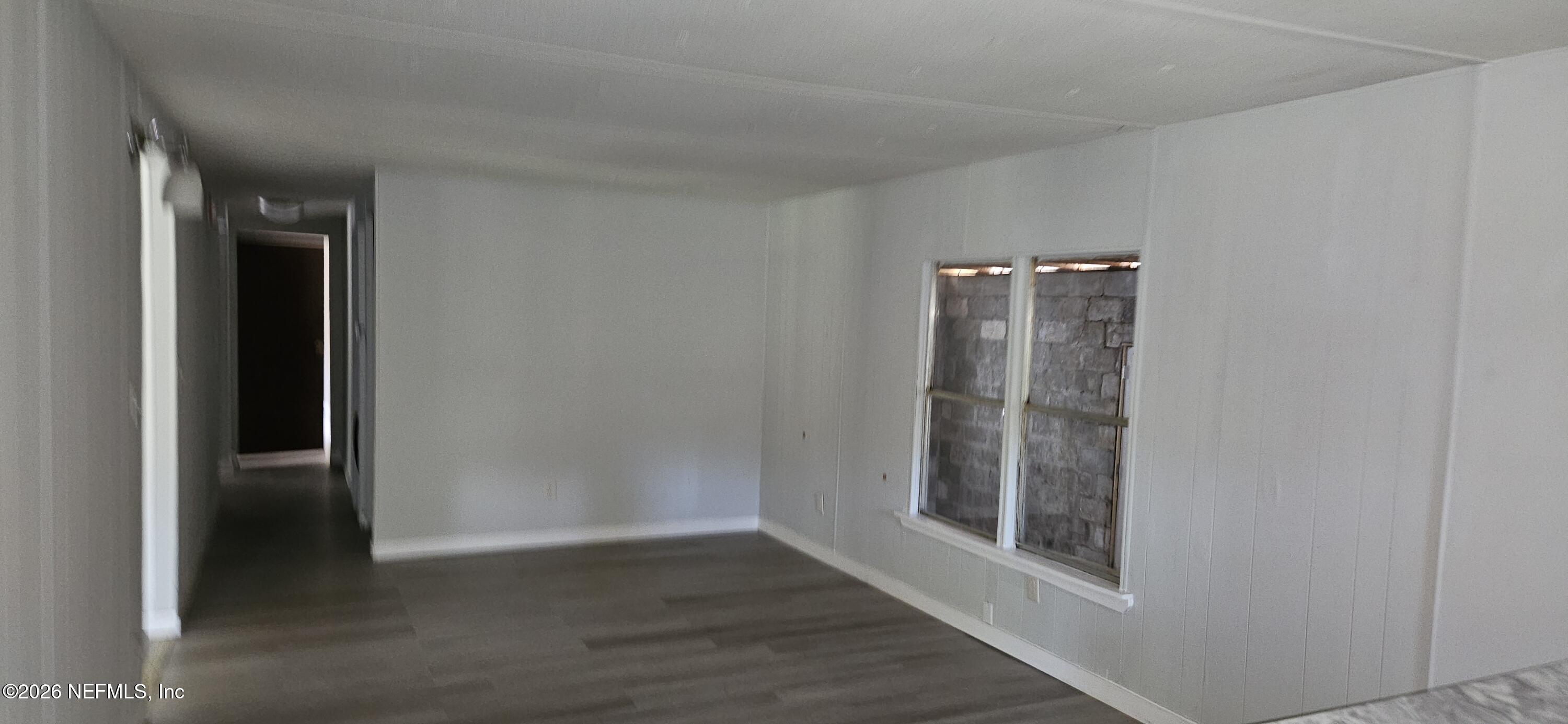 5363 Kilcrease Road Jacksonville, FL 32234 - Photo 10 of 29 an empty room with wooden floor and entrance