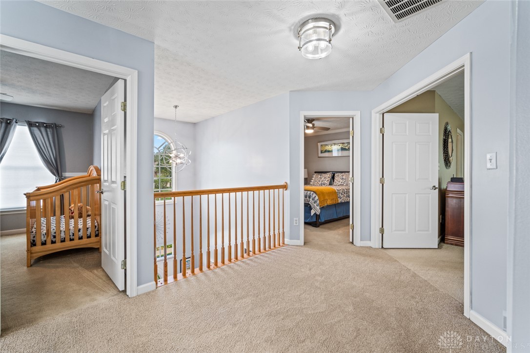 55 Janney Lane Springboro, OH 45066 - Photo 22 of 38 An inviting upper-level landing with plush carpeting and natural light offers a comfortable transition.