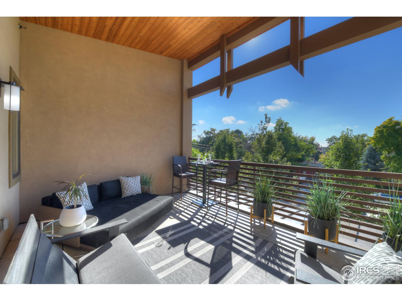 1217 High Street Boulder, CO 80304 - Photo 28 of 31 a view of balcony with couch and wooden floor