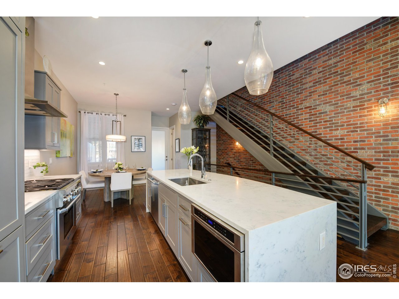 1217 High Street Boulder, CO 80304 - Photo 8 of 31 a kitchen with a sink stove and wooden floor