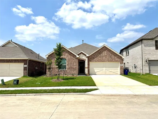 a view of a house with a big yard and large trees