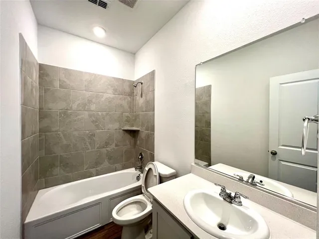 a bathroom with a sink a toilet and bathtub