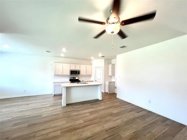 a view of kitchen with sink microwave and stove