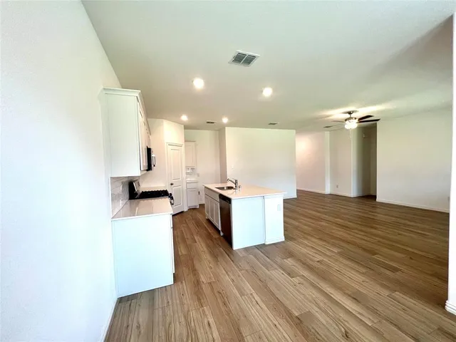 a view of kitchen with cabinets and wooden floor