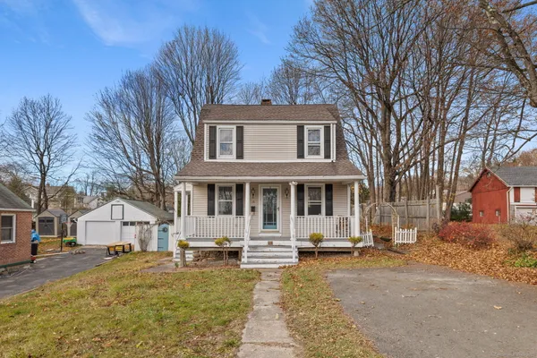 a front view of a house with a yard covered in snow
