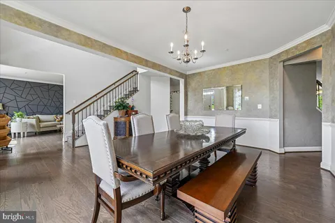 a view of a hallway with wooden floor and a living room