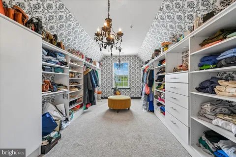 a bedroom with a bed a couch and dresser
