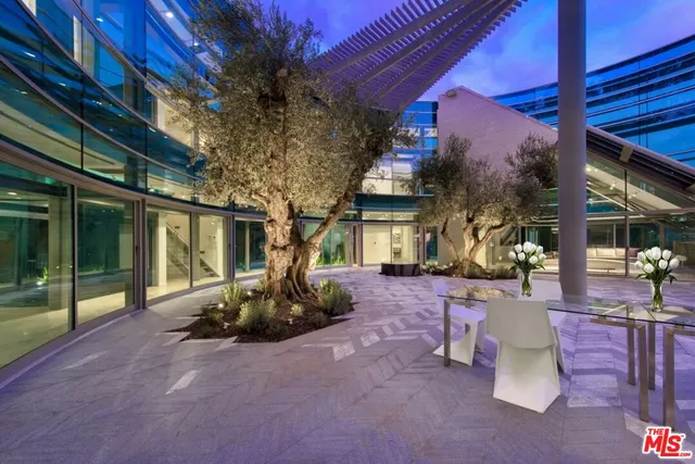 a view of a patio with table and chairs and potted plants