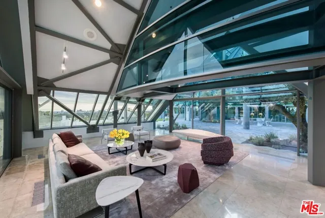 a living room with furniture and a floor to ceiling window