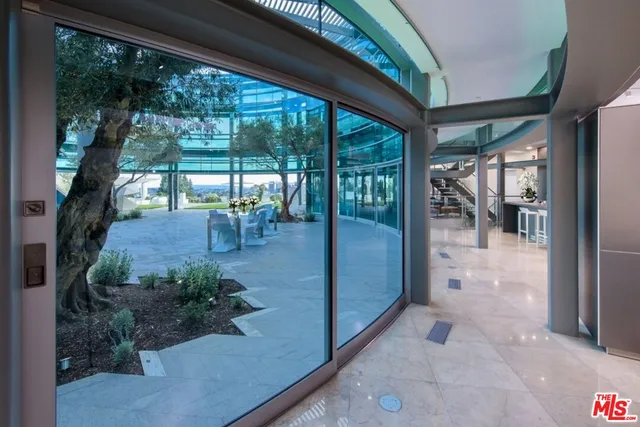 a view of a porch with chairs and backyard