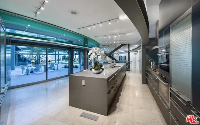 a kitchen with stainless steel appliances granite countertop a large stove a sink and a refrigerator