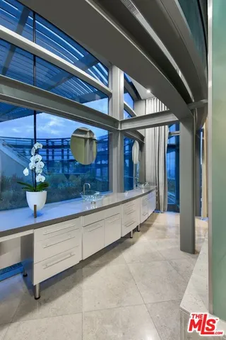 a bed room with a bed and painting on the wall