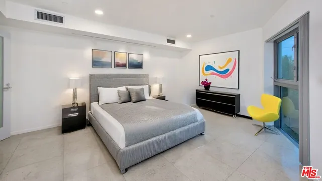 a bedroom with furniture and wooden floor