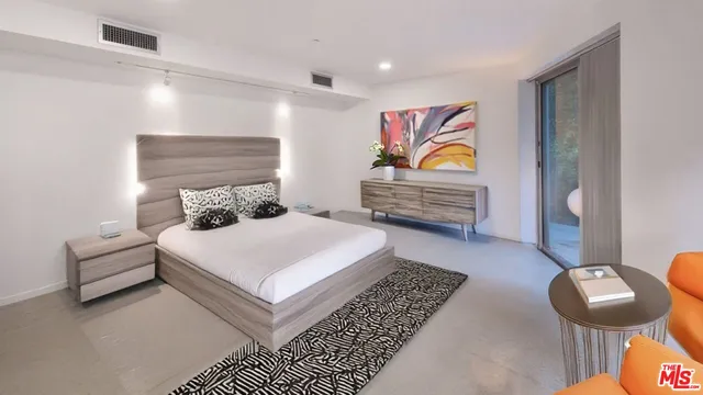 an aerial view of a house with garden space and a lake view