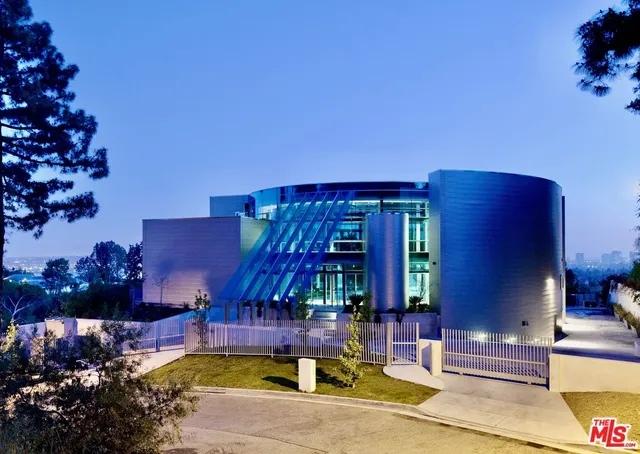 a front view of a house with a yard and tree s