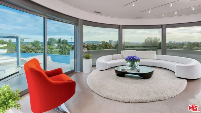 a living room with patio furniture and a potted plant