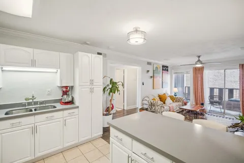 a kitchen with white cabinets and center island