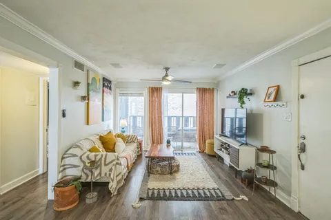 a living room with furniture window and wooden floor