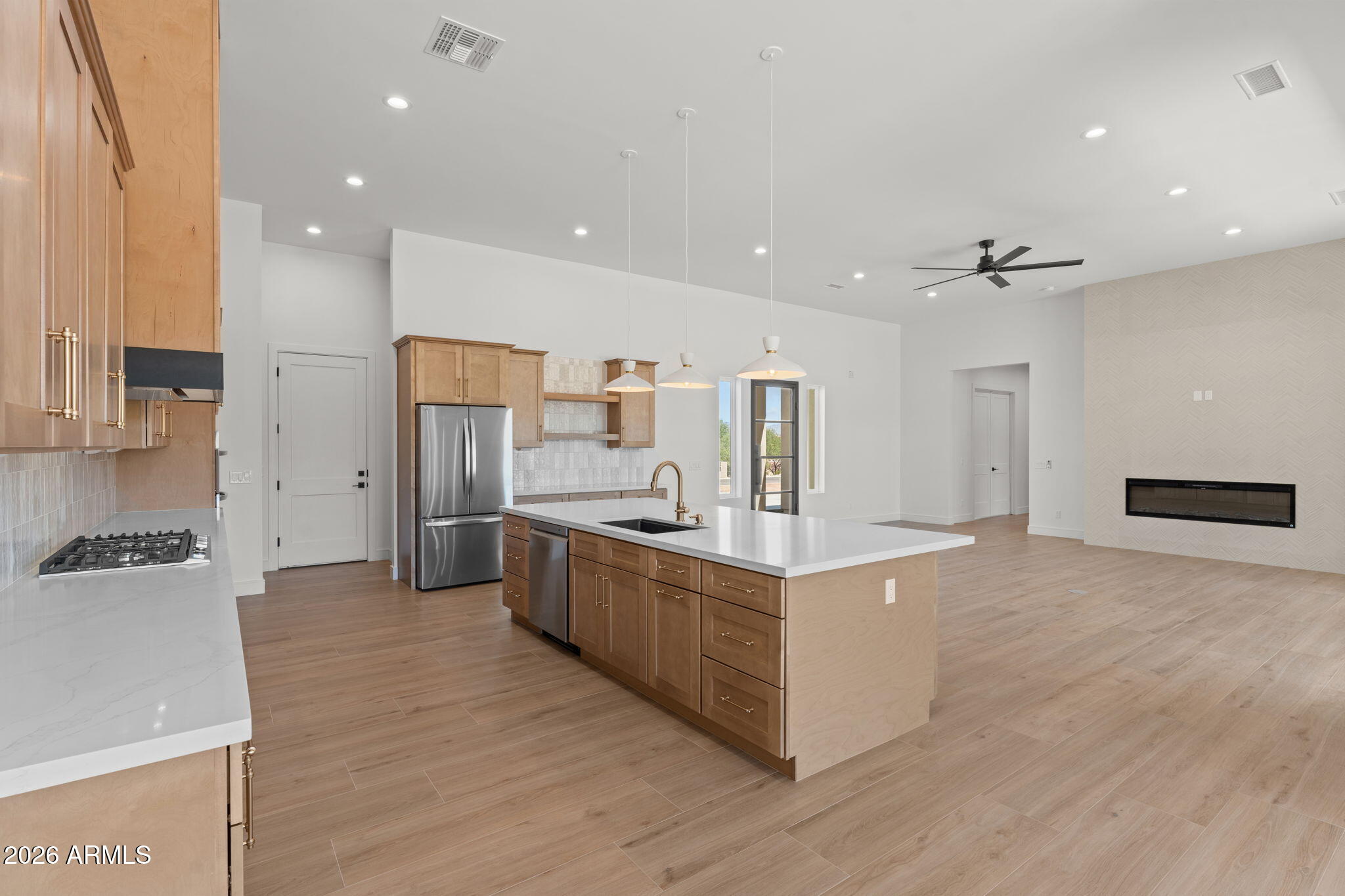2855 Percheron Road Wickenburg, AZ 85390 - Photo 23 of 58 a large kitchen with stainless steel appliances a large counter top a sink a stove a refrigerator and white cabinets