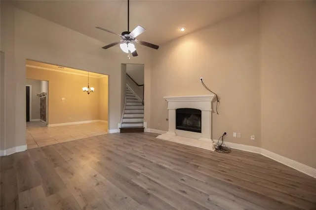 a view of a livingroom with a fireplace and wooden floor