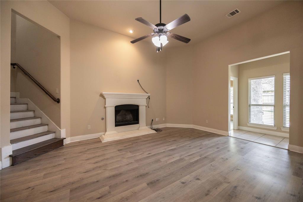 10500 Musketball Place McKinney, TX 75072 - Photo 12 of 40 an empty room with wooden floor fan and windows