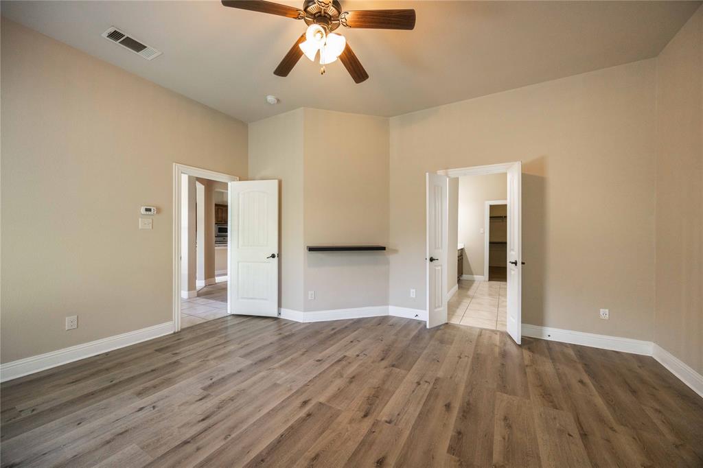 10500 Musketball Place McKinney, TX 75072 - Photo 20 of 40 a view of an empty room with wooden floor and a ceiling fan