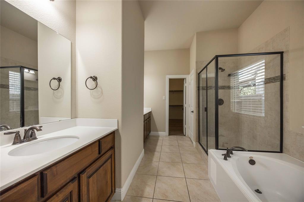 10500 Musketball Place McKinney, TX 75072 - Photo 21 of 40 a bathroom with a tub sink and mirror