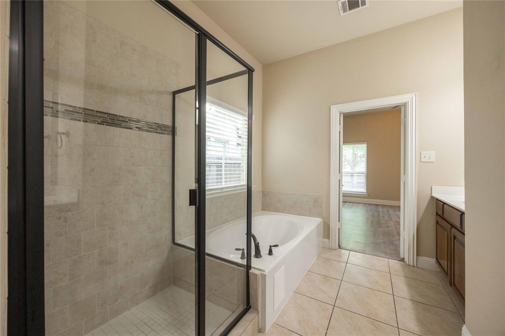 10500 Musketball Place McKinney, TX 75072 - Photo 22 of 40 a bathroom with a tub and shower
