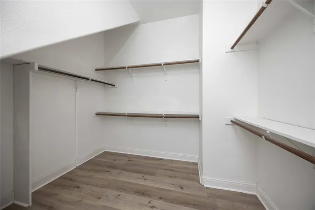 a view of an empty room and wooden floor