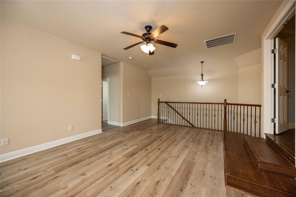 10500 Musketball Place McKinney, TX 75072 - Photo 26 of 40 a view of a livingroom with a ceiling fan and wooden floor