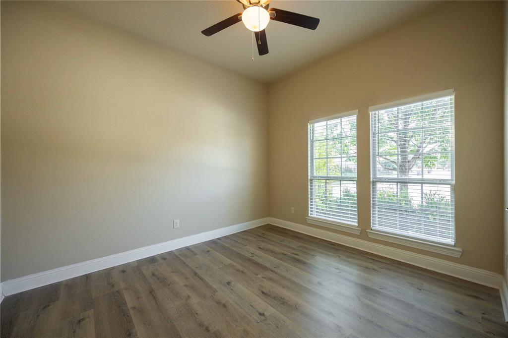 10500 Musketball Place McKinney, TX 75072 - Photo 3 of 40 a view of an empty room with wooden floor and a window