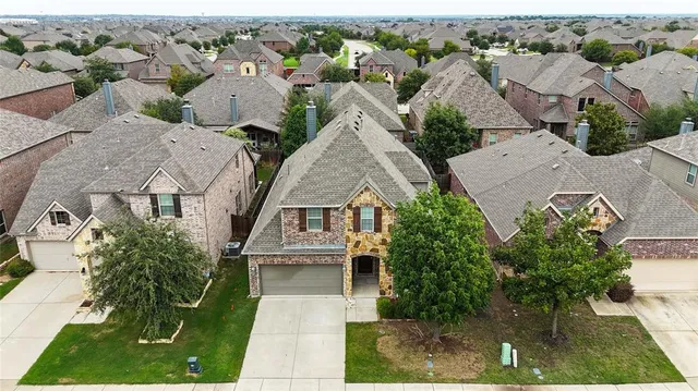 an aerial view of multiple houses with yard