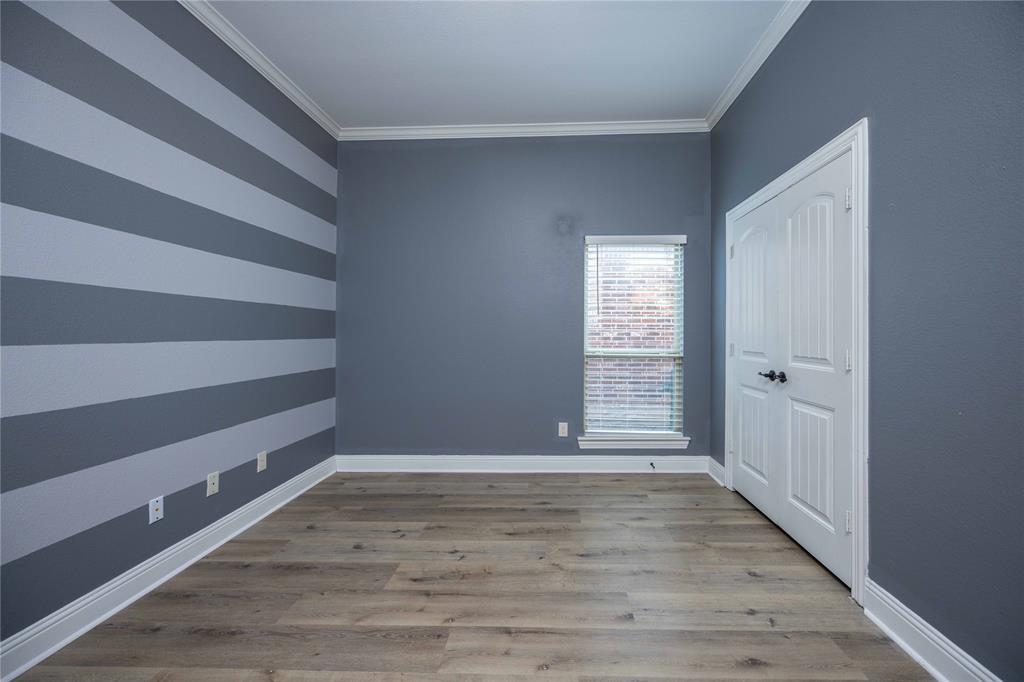 10500 Musketball Place McKinney, TX 75072 - Photo 7 of 40 a view of an empty room with wooden floor and a window